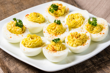 Deviled eggs garnished with parsley and paprika