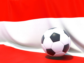 Flag of austria with football in front of it