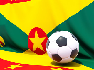 Naklejka premium Flag of grenada with football in front of it