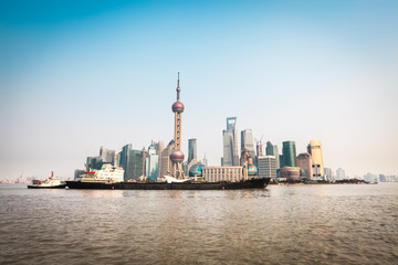 shanghai skyline and cargo ship