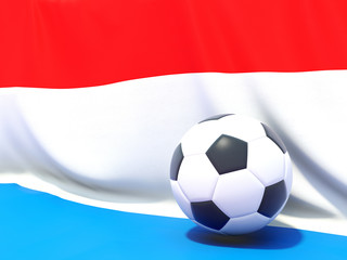Naklejka premium Flag of luxembourg with football in front of it