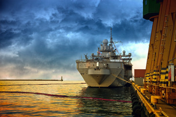 Warship in the port of dramatic scenery.