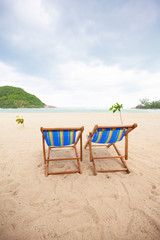 Fototapeta na wymiar Beach chairs at sea front