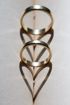 Gold wedding rings and heart of the shadows