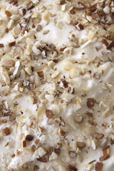 Close Up of Chopped Mixed Nuts And Whipped Cream On Christmas Tr