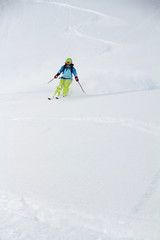 Skier in deep powder, extreme freeride