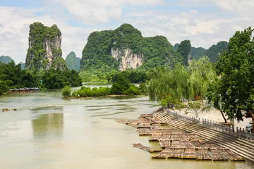 Zelfklevend Fotobehang Bamboo rafts in idyllic li river scenery yangshuo china © Juhku