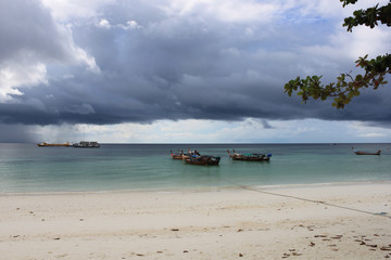 Fototapeta premium Longtail boats lined up before a storm