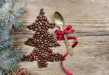Golden spoon decorated with red bow on wooden table. Top view