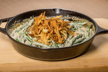Fried onions with beans in a cast iron skillet