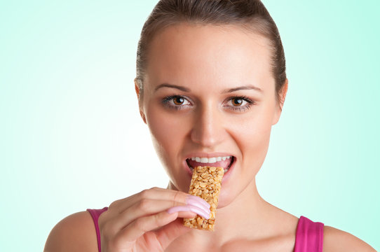 Woman Eating A Cereal Bar