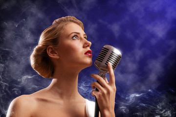 beautiful blonde woman singer with a microphone