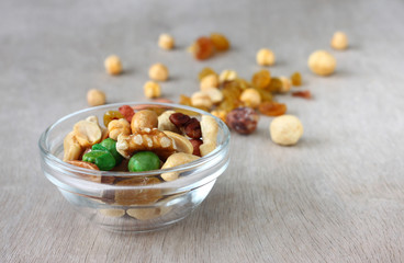 Assorted healthy mixed nuts on wooden textured background  