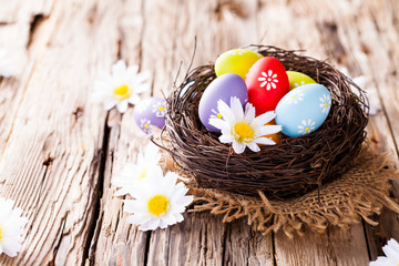 Easter colored eggs on wood