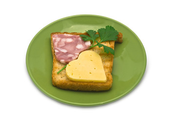 Toast with heart-shaped Sausage and Cheese on Green Plate isolat