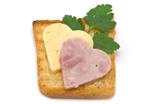 Toast with heart-shaped Ham and Cheese isolated on white