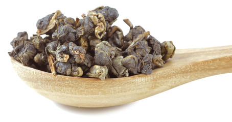 tea and wooden spoon on a white background