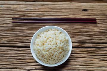 Bowl of brown rice with chopsticks