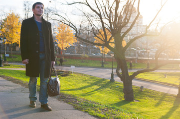 Man with bag on the road in park