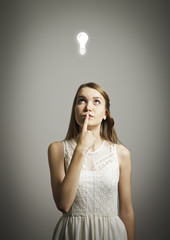 Girl in white and light bulb
