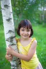 The girl is under the birch and the smiles