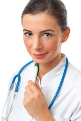 Thoughtful smiling doctor female holding green pen on the chin