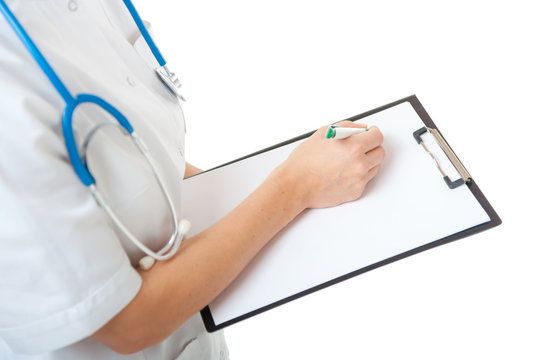 Woman doctor writing on blank clipboard on white background