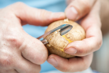Man peeling potato