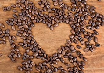 coffee beans on wooden background. heart