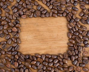 coffee beans on wooden background. frame