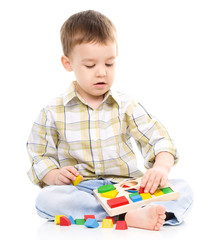 Little boy is playing with toys
