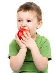 Portrait of a cute little boy with red apple