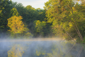 Fototapeta premium Morning mist raising on a lake