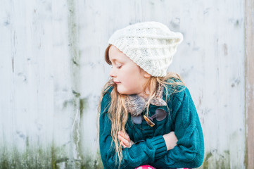 Outdoor portrait of a cute little girl on a chilly day