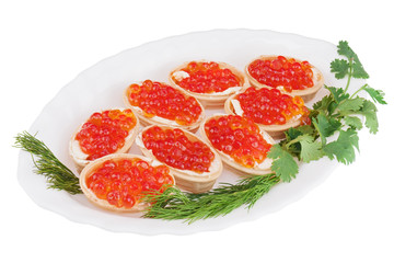 Tartlets with red caviar on plate isolated on white background.
