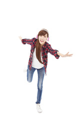 Young woman with headphones listening music and dancing