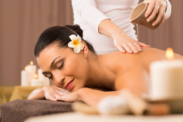 Fototapeta na wymiar Woman Having A Back Oil Massage