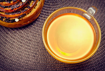 Bun & tea on tablecloth.