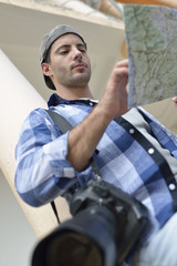 Photo reporter looking at street map