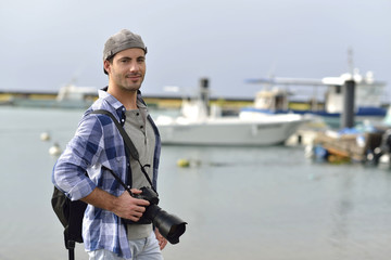 Photographer standing by fishing harbour