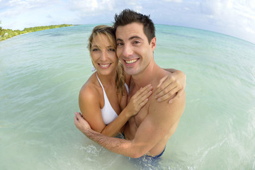 Fototapeta premium Couple having fun at the beach