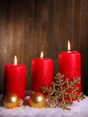 Burning candles on wooden background