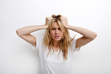 Portrait of frustrated woman pulling against white background