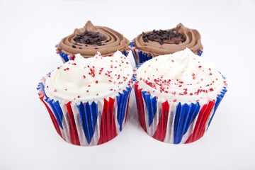 Various Union Jack cupcakes against white background