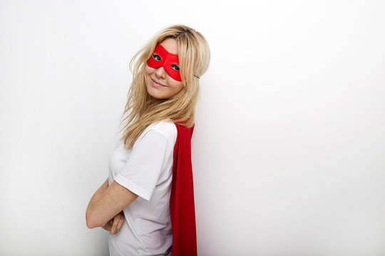 Side view portrait of confident woman in superhero against white background