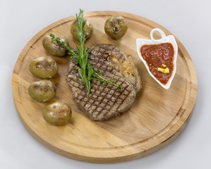 Мясной стейк с картофелем на дерев