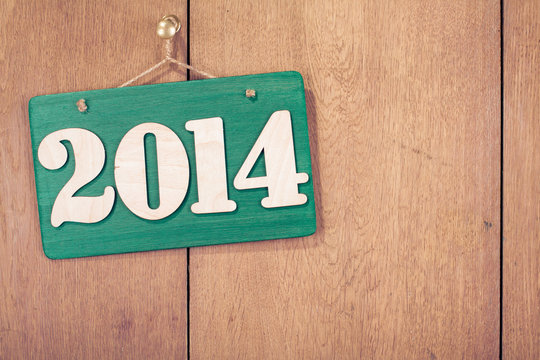 New Year date on signboard front wooden wall background