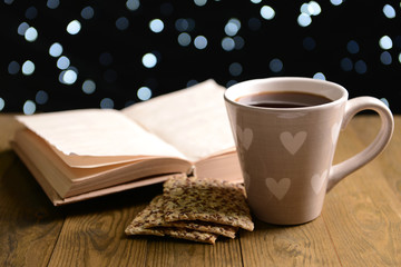Composition of book with cup of coffee