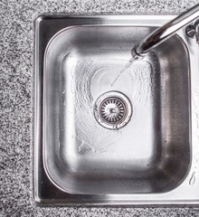 Water flowing down the hole in a kitchen sink