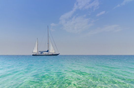 Seascape with sailboat at sea horizon
